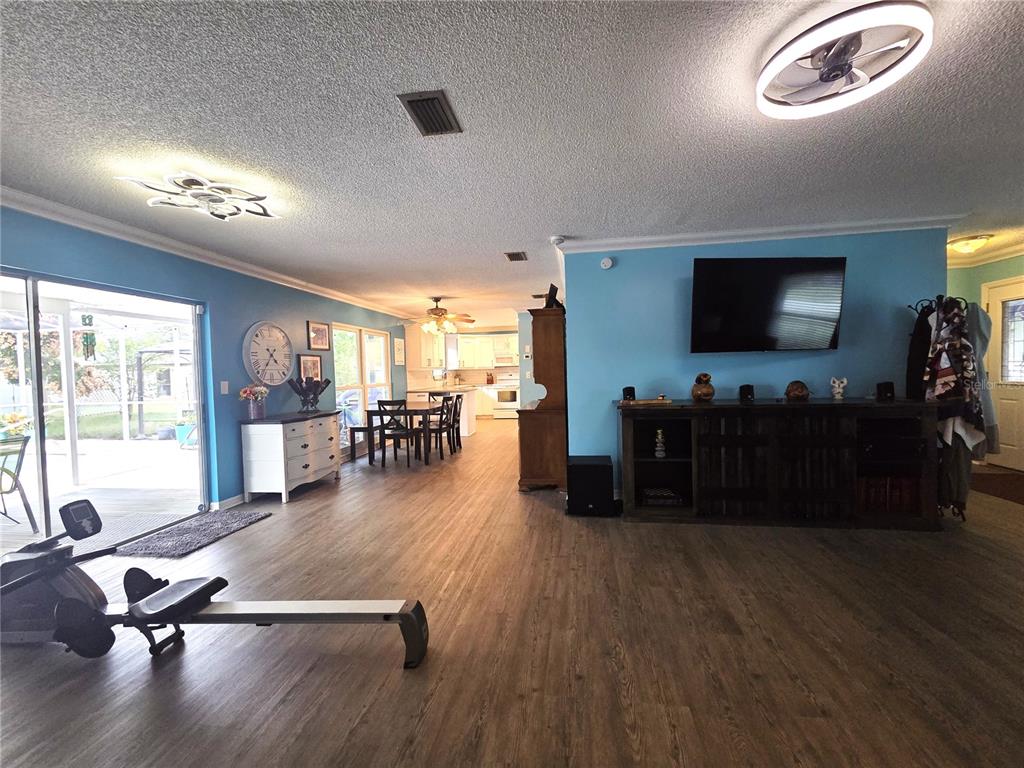 4059 Ligonier Road Spring Hill, FL 34608 - Photo 9 of 36 a living room with furniture and a flat screen tv