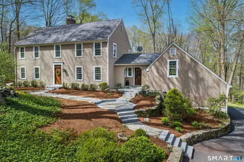 a front view of a house with a yard and outdoor seating