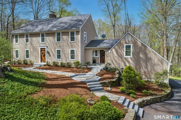 a front view of a house with a yard and outdoor seating