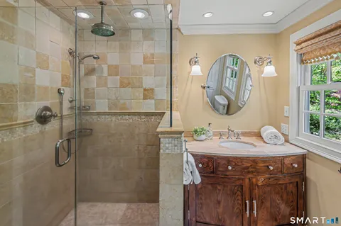 a bathroom with a sink vanity and a mirror