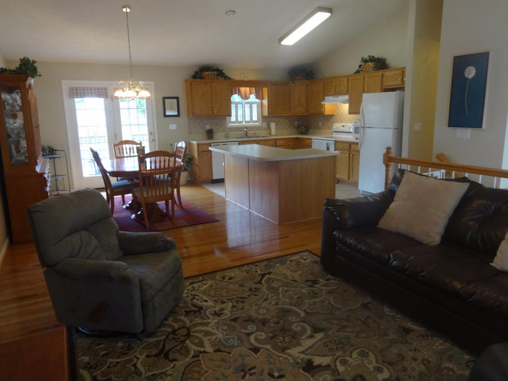 1732 Meadows Road Vinton, VA 24179 - Photo 17 of 32 a living room with furniture and a dining table with kitchen view