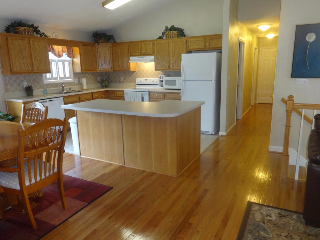 1732 Meadows Road Vinton, VA 24179 - Photo 21 of 32 a kitchen with stainless steel appliances granite countertop a sink a stove a dining table and chairs