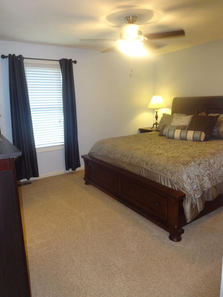 1732 Meadows Road Vinton, VA 24179 - Photo 23 of 32 a bed sitting in a bedroom next to a window