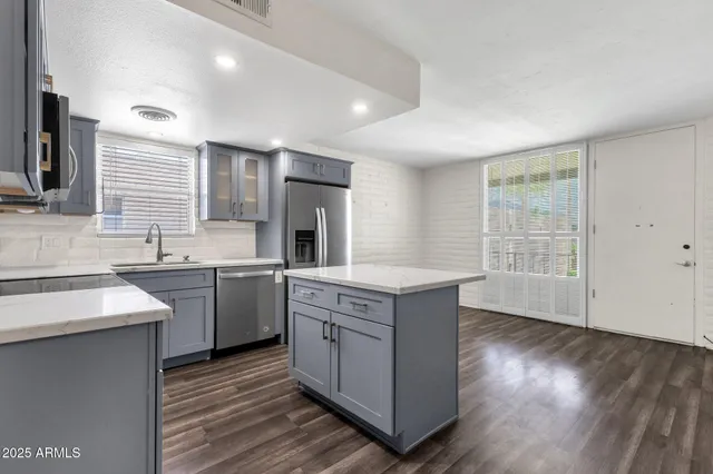 a kitchen with a sink stove and wooden cabinets