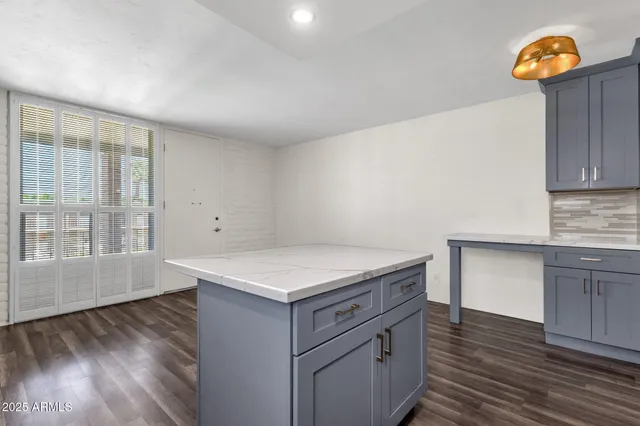 a kitchen with a wooden floor and a window