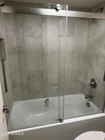 a bathroom with a shower and a bathtub