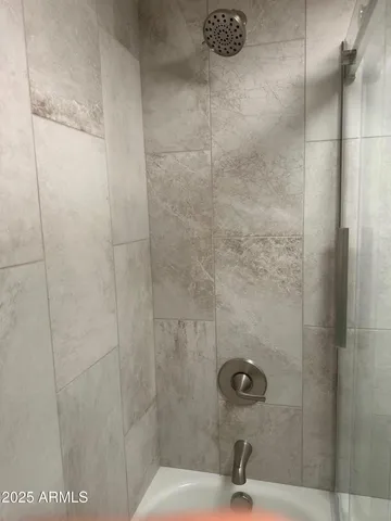 a bathroom with a bathtub and shower
