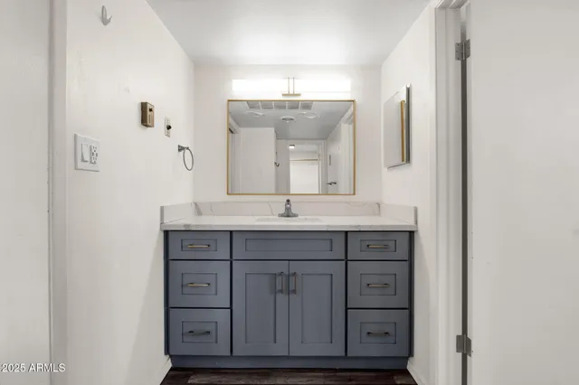 a bathroom with a granite countertop sink a mirror and a