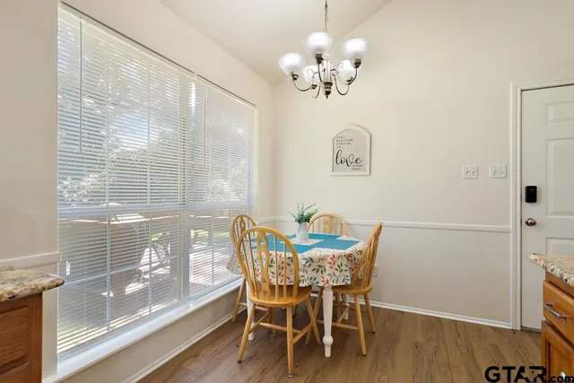 a view of a dining room with furniture and wooden floor