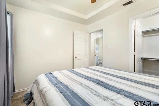 a bedroom with a bed and a mirror