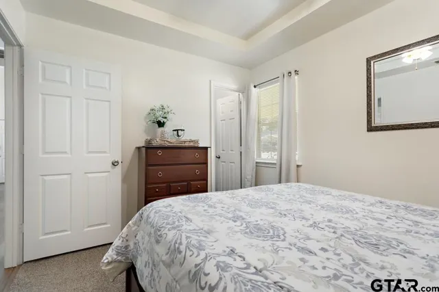 a bedroom with a bed and a dresser