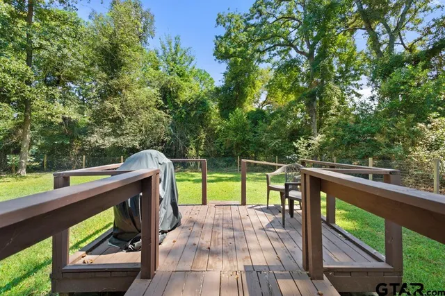 a view of deck with chairs and wooden fence