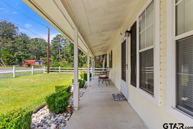 a view of a porch with chairs and backyard