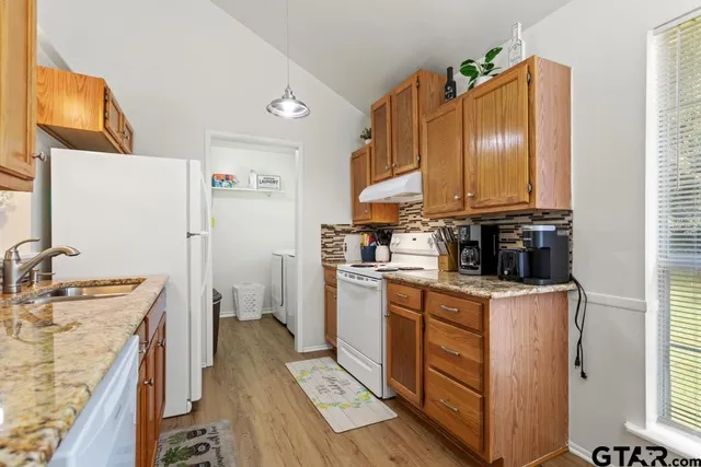 a kitchen with a sink stove and refrigerator
