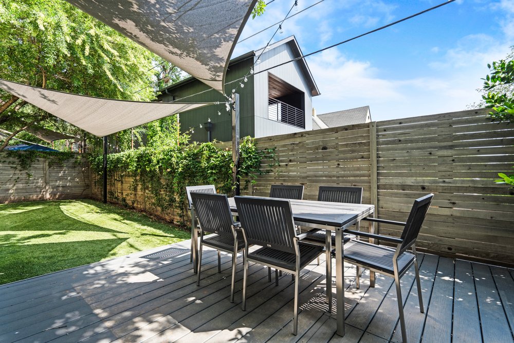 1609 Hartford Road, Unit A Austin, TX 78703 - Photo 7 of 39 An inviting backyard oasis features a spacious deck, artificial turf, and privacy fence.