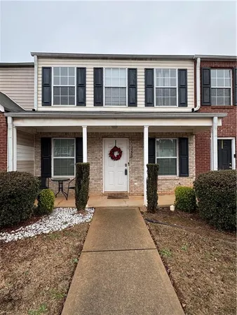 front view of a brick house with a yard