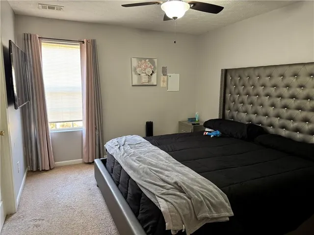 a bedroom with bed and a window