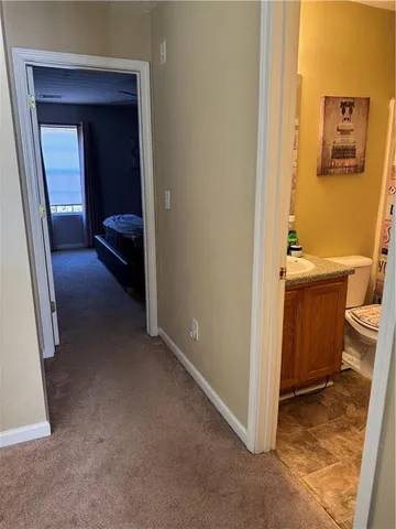 a view of a hallway and a livingroom with furniture