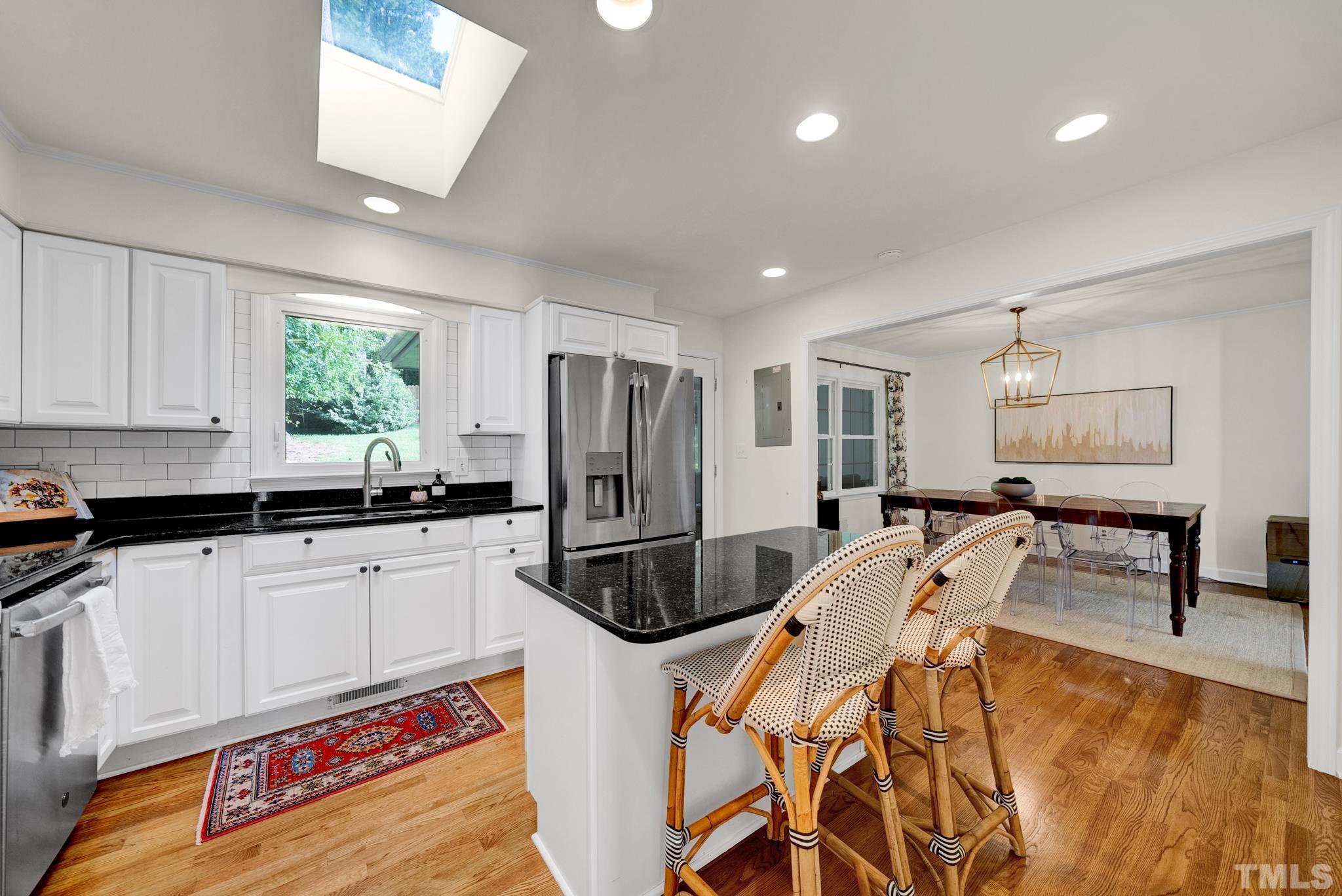 604 Sampson Street Raleigh, NC 27609 - Photo 2 of 3 a kitchen with stainless steel appliances granite countertop a sink a stove and a refrigerator