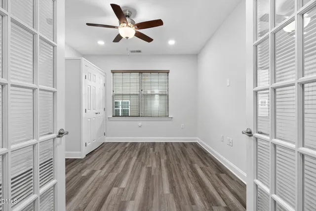 a view of a hallway with wooden floor and staircase