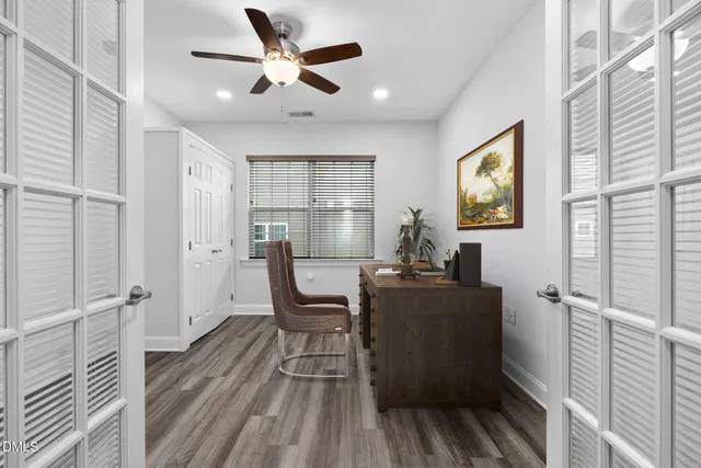 a workspace with wooden floor and windows
