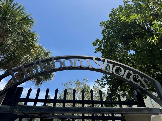 a view of a brick house with a large window and plants
