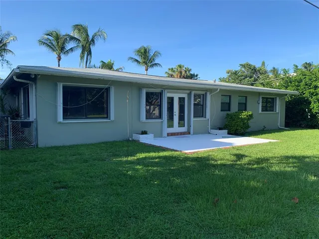 a view of a house with a yard and plants