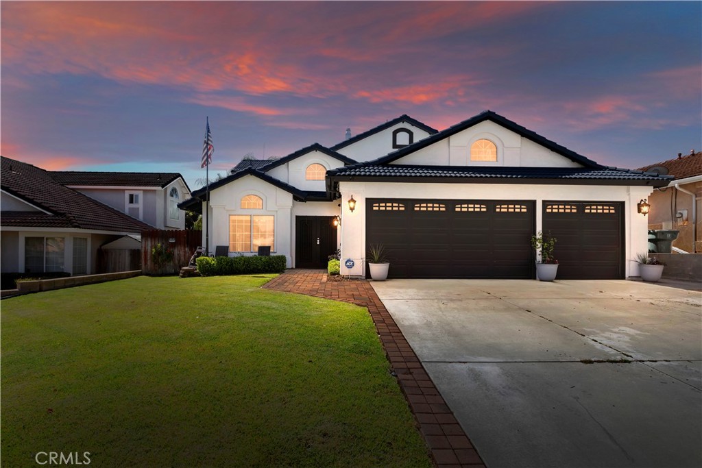 8530 Rosemary Drive Riverside, CA 92508 - Photo 1 of 1 a front view of a house with a yard and garage