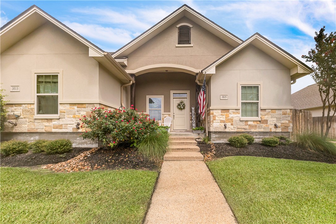 View of front of property featuring stone siding a