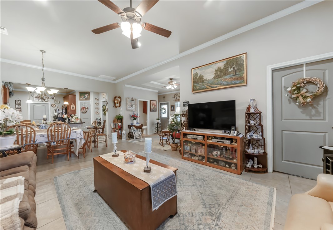 3815 Harvey Road College Station, TX 77845 - Photo 5 of 24 Living room with a ceiling fan, tile patterned flo