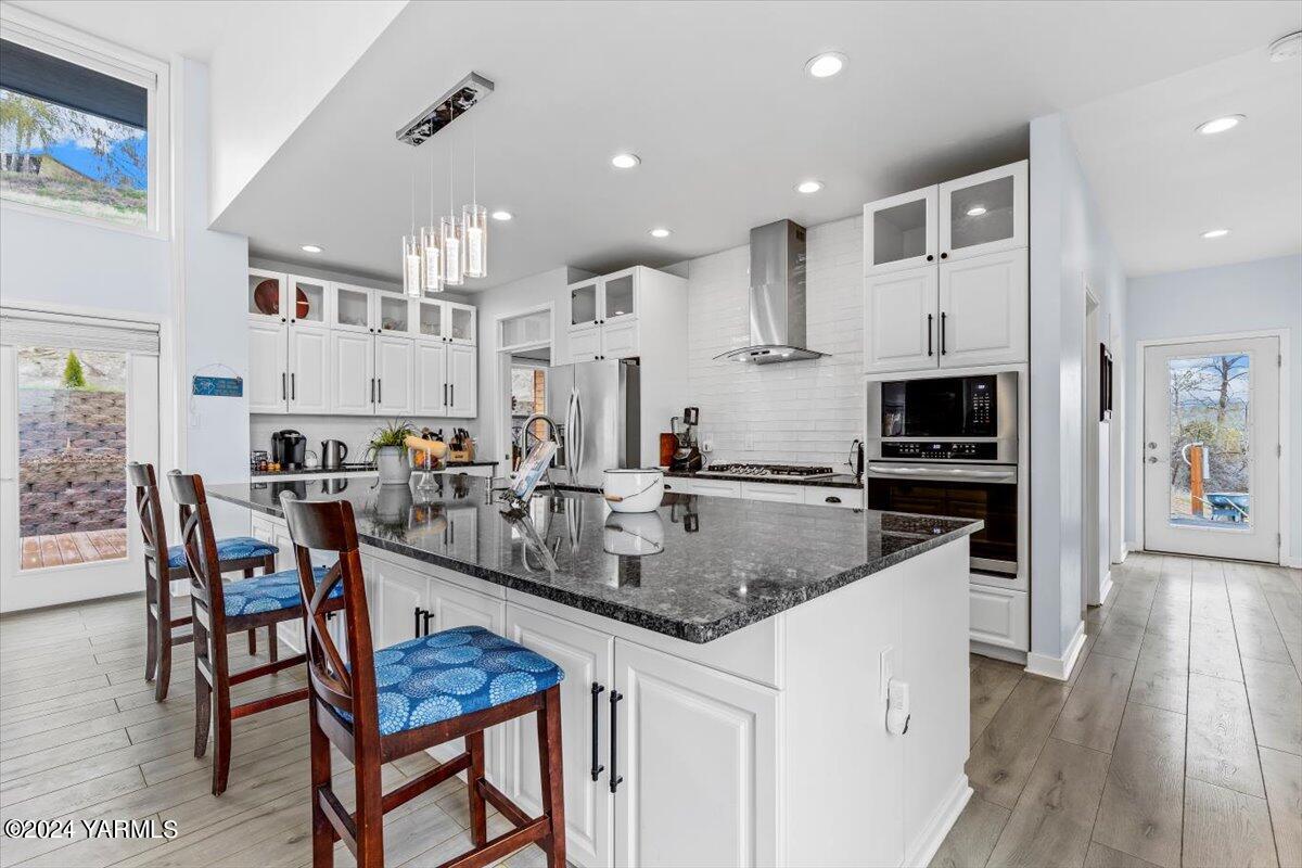 925 Goodlander Circle Selah, WA 98942 - Photo 10 of 37 a kitchen with stainless steel appliances granite countertop a stove top oven a sink a dining table and chairs