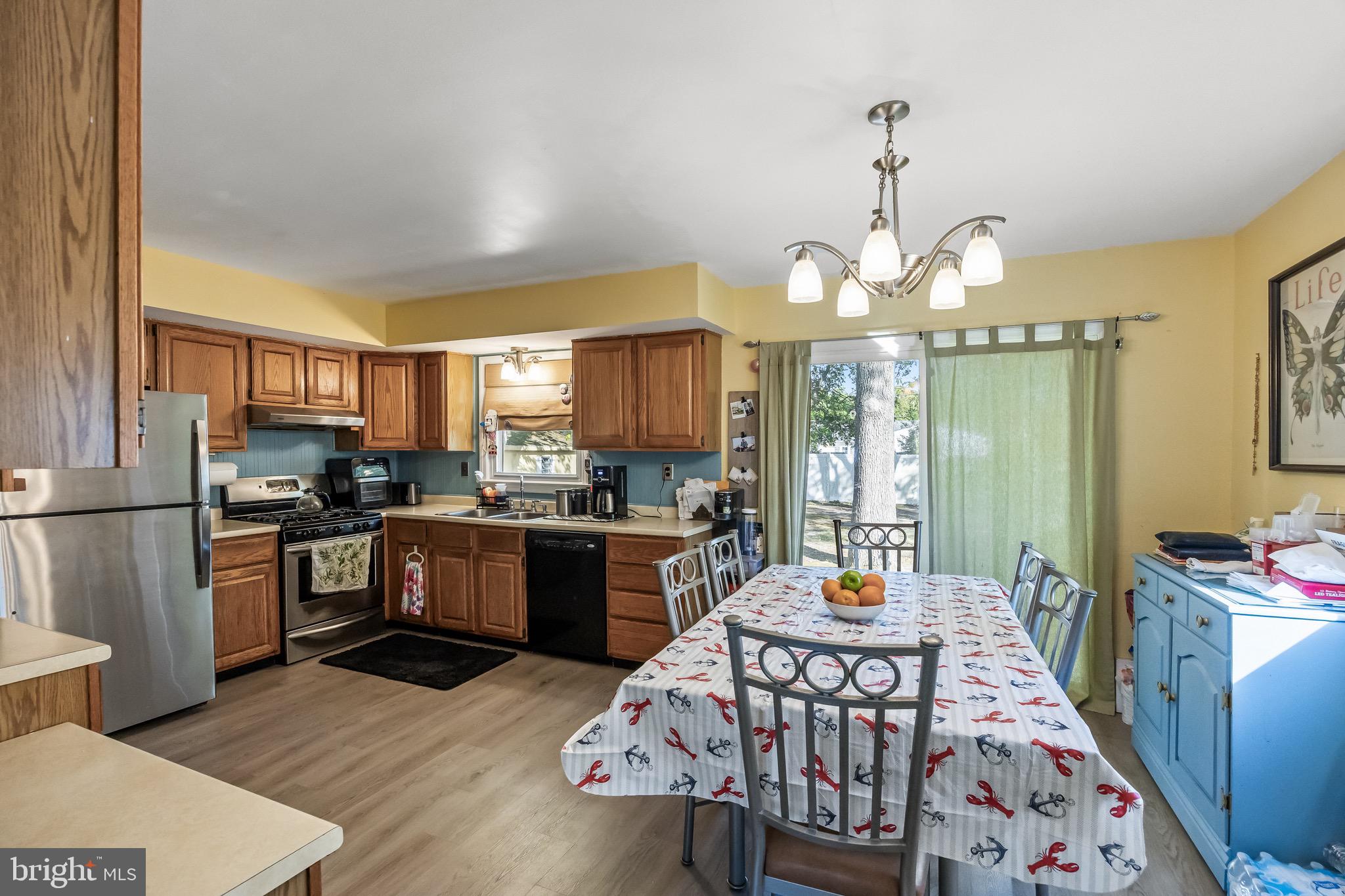 109 North Ambler Road Somers Point, NJ 08244 - Photo 11 of 22 a kitchen with sink refrigerator dining table and chairs