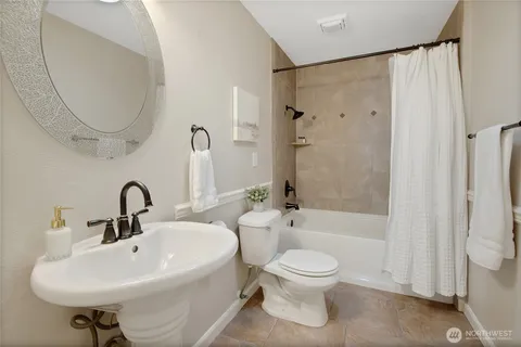 a bathroom with a toilet sink and a mirror