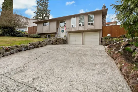 a front view of a house with a yard and garage