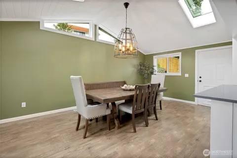 a view of a dining room with furniture and a chandelier