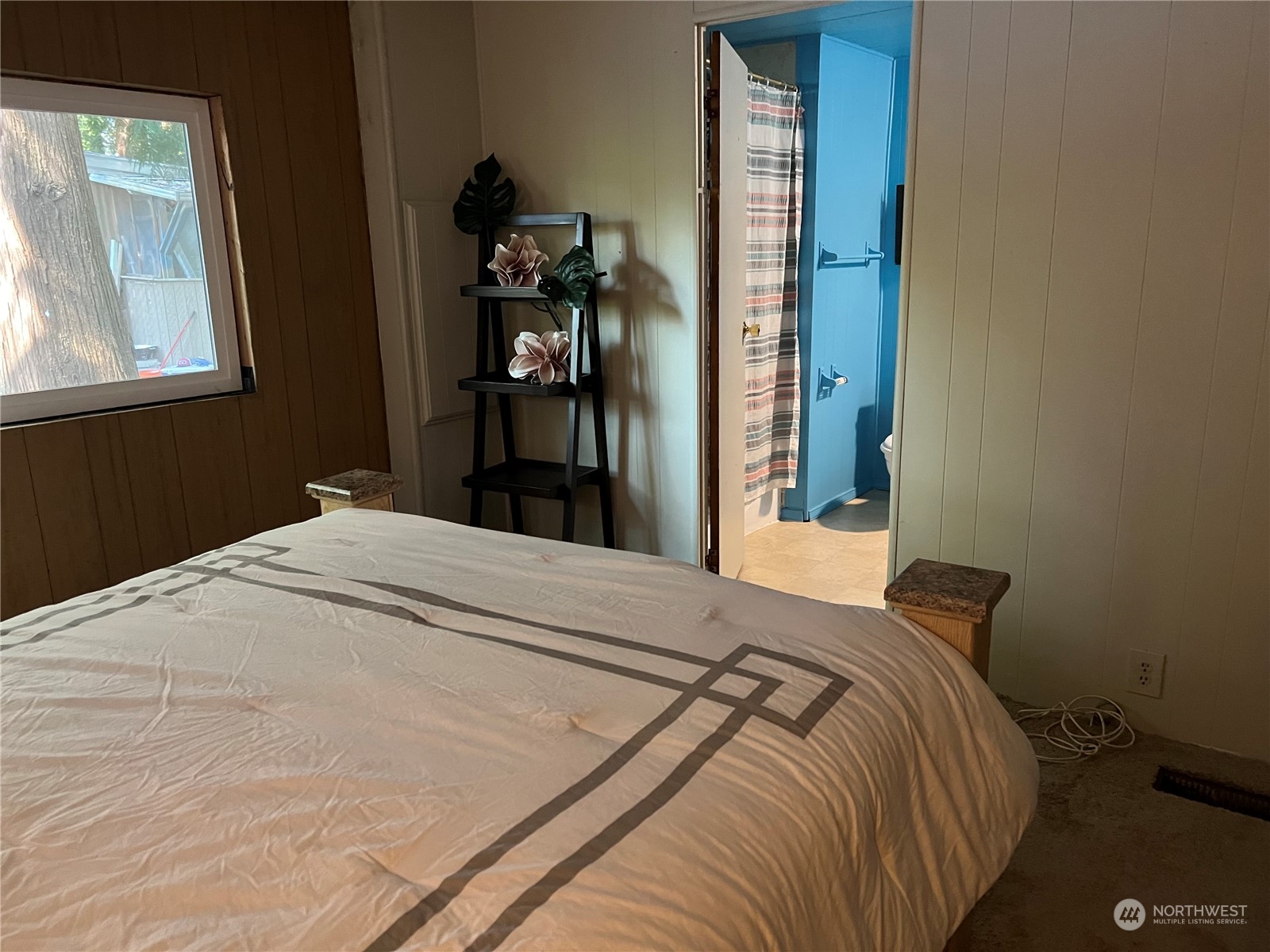 1729 Southeast 194th Street, Unit 32 Bothell, WA 98012 - Photo 17 of 19 a bed sitting in a bedroom next to a window