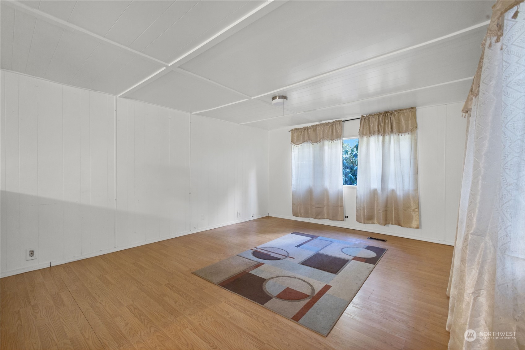 1729 Southeast 194th Street, Unit 32 Bothell, WA 98012 - Photo 7 of 19 an empty room with wooden floor and windows