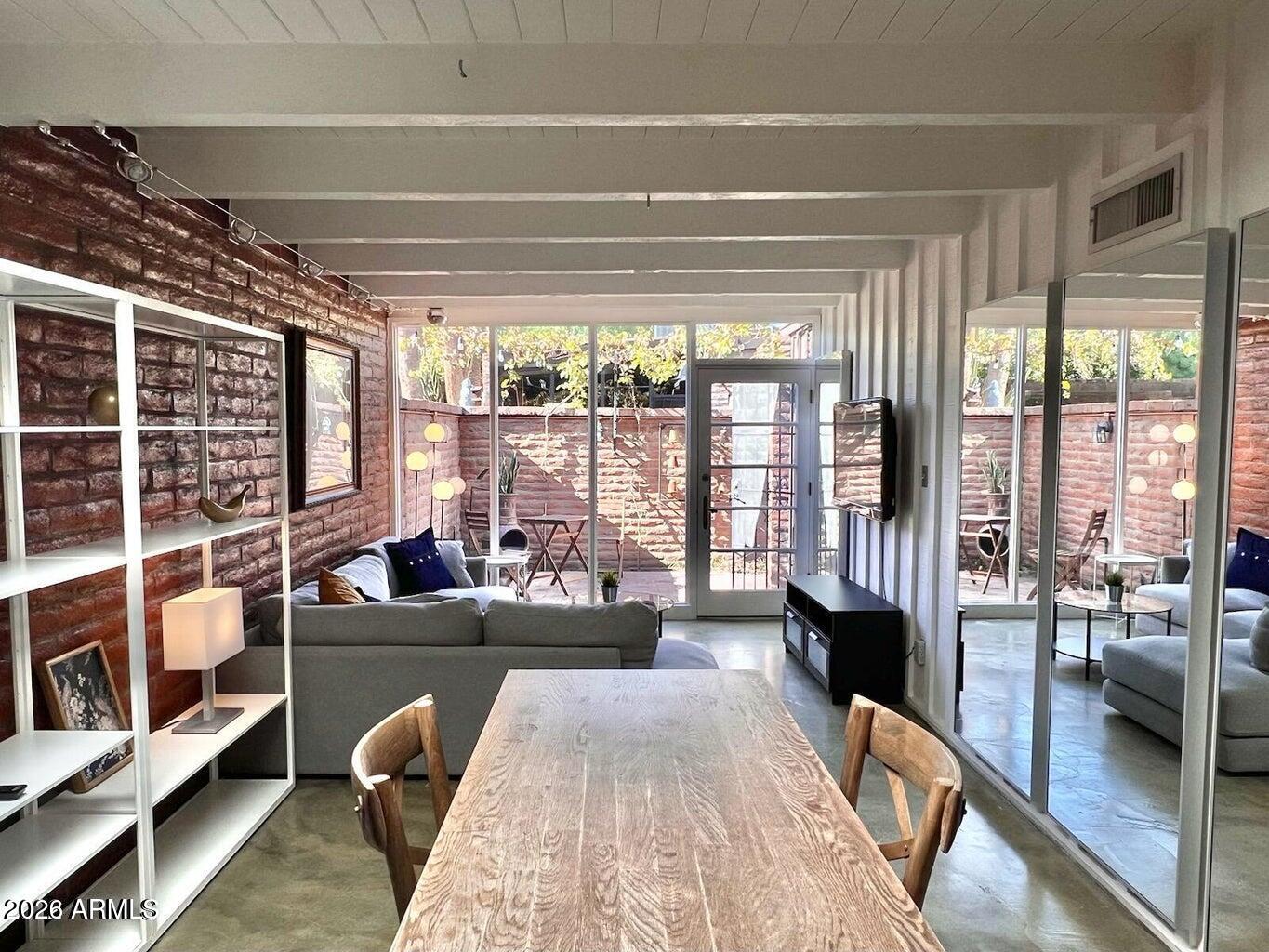 3022 North 32nd Street, Unit 51 Phoenix, AZ 85018 - Photo 1 of 19 a living room with furniture and a large window