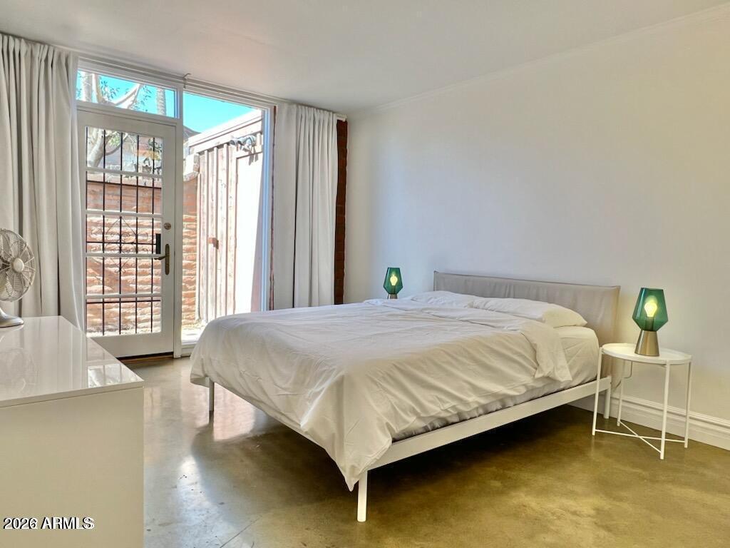 3022 North 32nd Street, Unit 51 Phoenix, AZ 85018 - Photo 12 of 19 a bed sitting in a bedroom next to a window