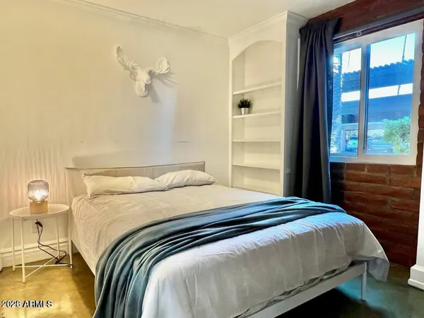 a bedroom with a bed and a window