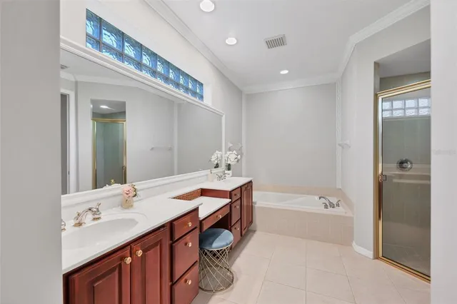 a bathroom with a sink a large mirror and a bathtub