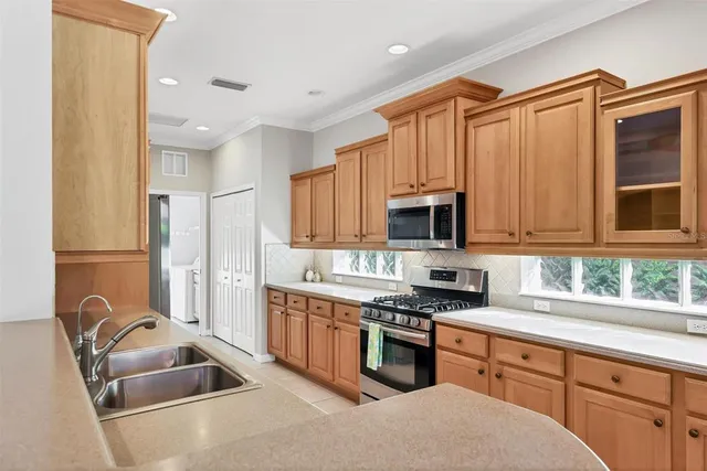 a kitchen with stainless steel appliances granite countertop a sink stove and refrigerator