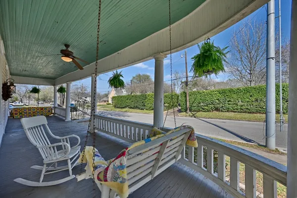 a view of a chairs and table in the balcony