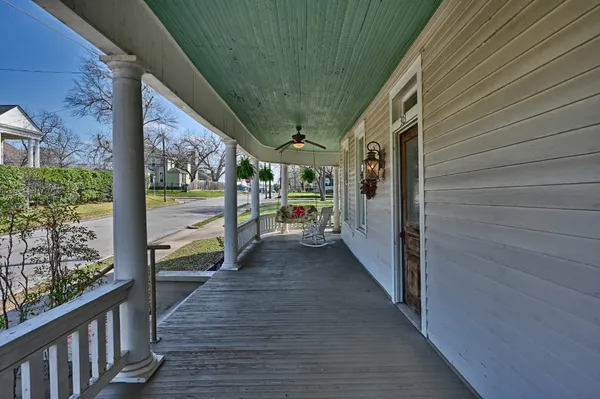 a view of a porch with wooden floor