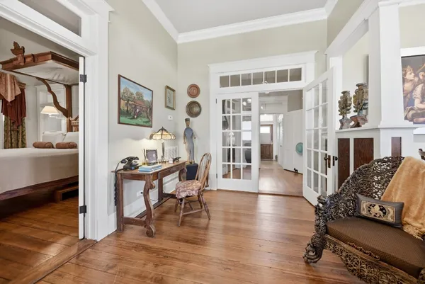 a living room with furniture and a wooden floor