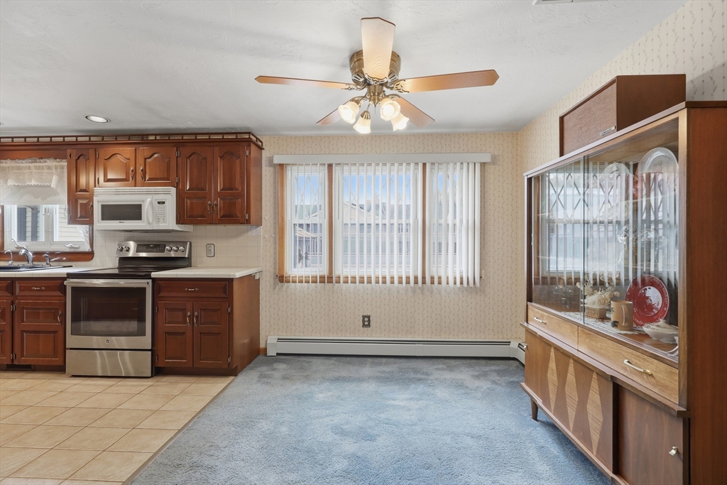 10 Deluca Road Milford, MA 01757 - Photo 10 of 37 a kitchen with stainless steel appliances kitchen island granite countertop a stove a sink and a refrigerator