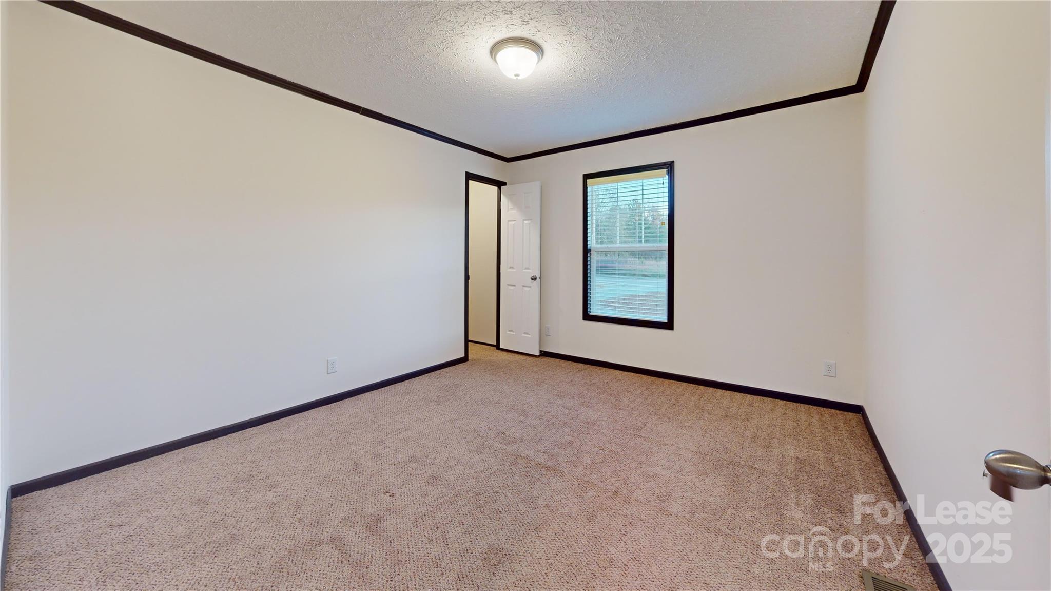 7708 Waxhaw Highway Waxhaw, NC 28173 - Photo 15 of 28 an empty room with windows