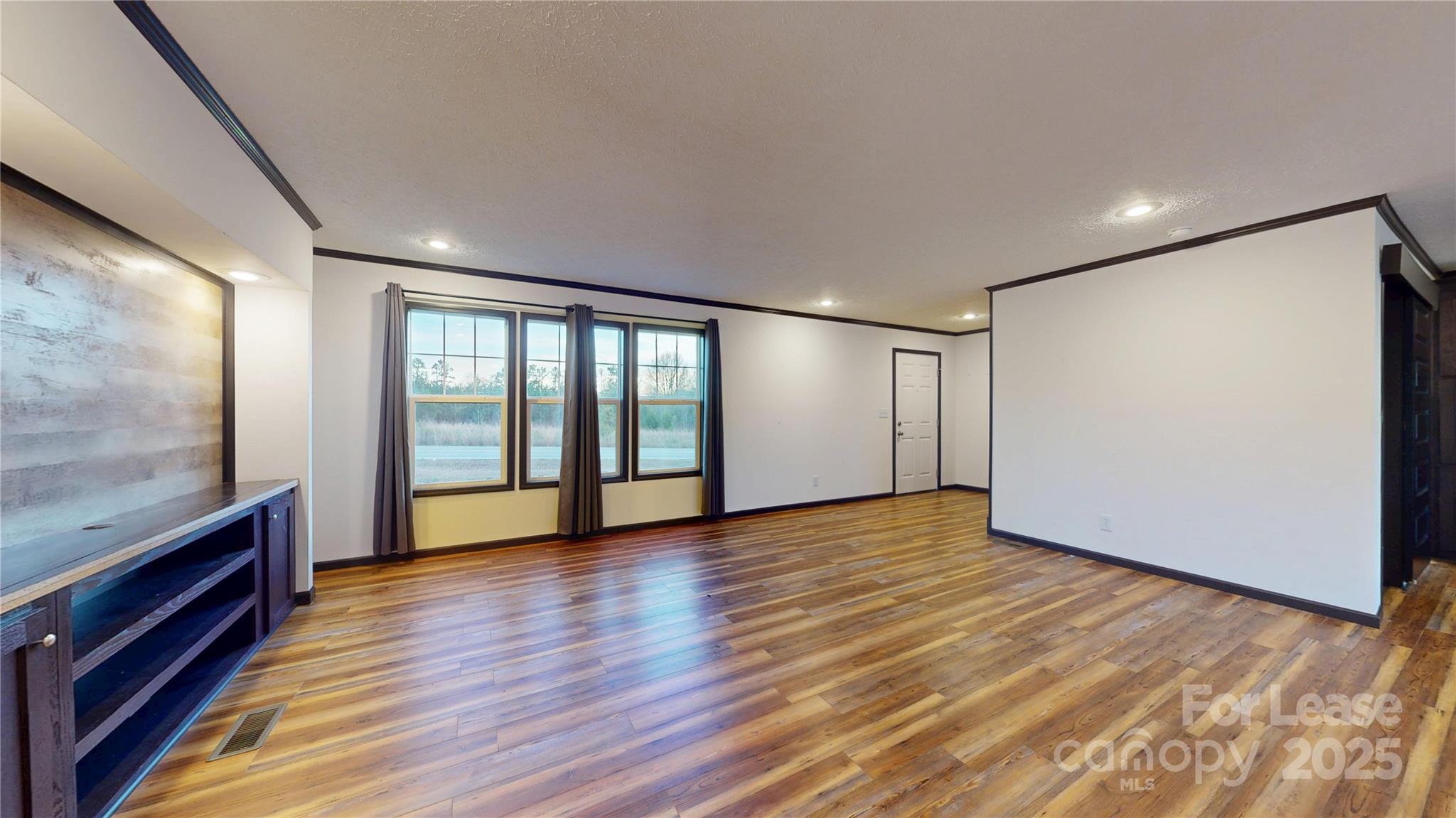 7708 Waxhaw Highway Waxhaw, NC 28173 - Photo 5 of 28 a view of an empty room with wooden floor and a window