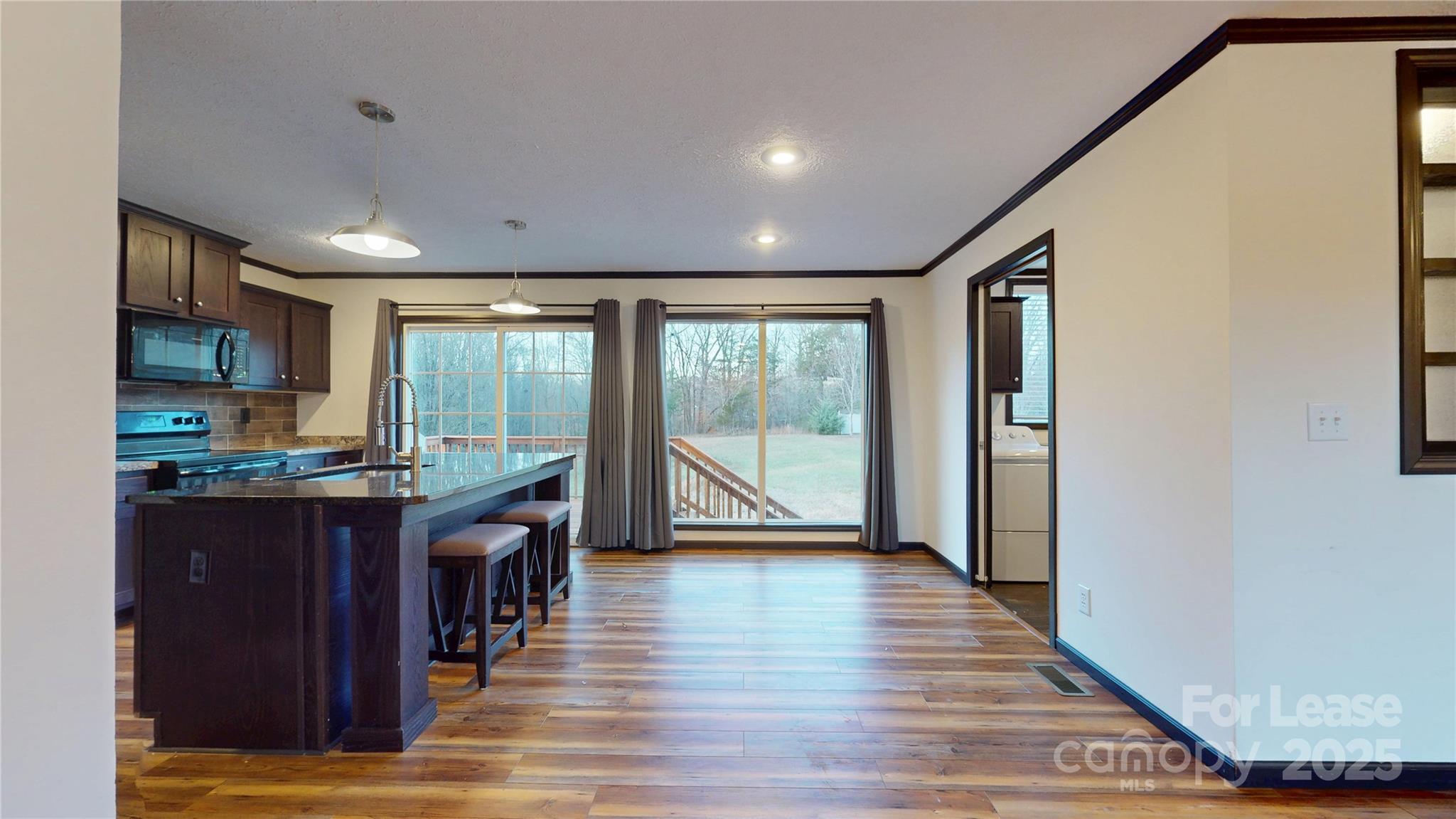 7708 Waxhaw Highway Waxhaw, NC 28173 - Photo 6 of 28 a living room with stainless steel appliances granite countertop furniture wooden floor and a window