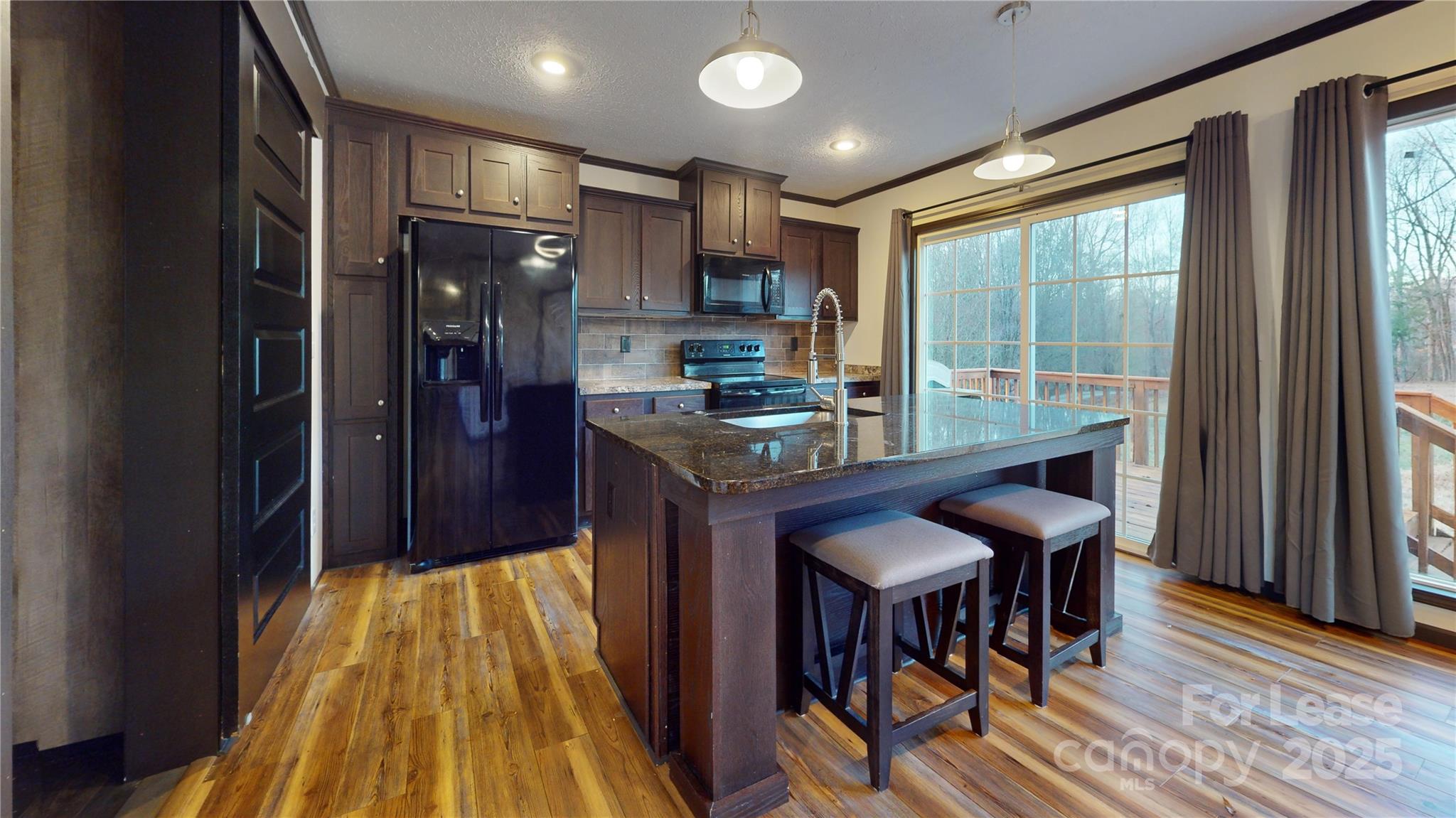 7708 Waxhaw Highway Waxhaw, NC 28173 - Photo 8 of 28 a kitchen with stainless steel appliances granite countertop a stove and a refrigerator